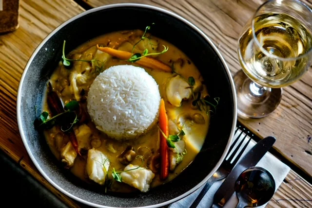 Evening dish served with rice and wine at Guys Bar