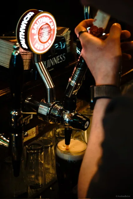 A pint being poured behind the bar at Guys Bar
