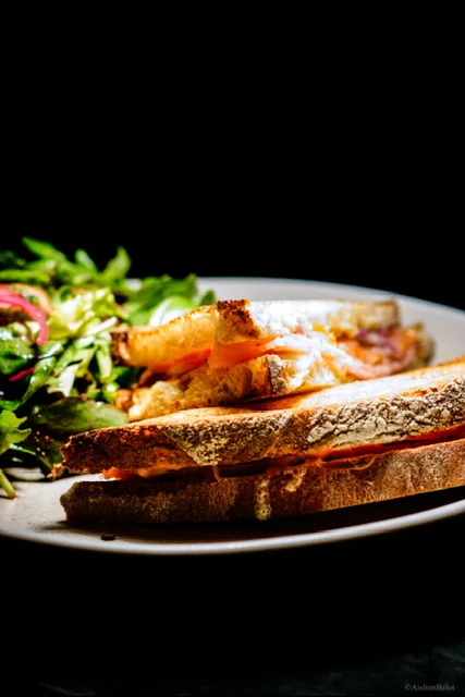 A sandwich served with salad at Guys Bar